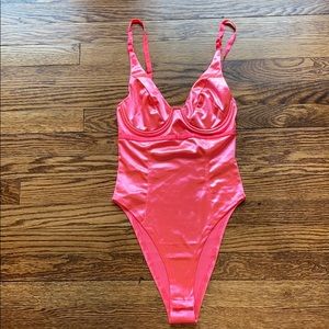 Bright pink body suit never worn.